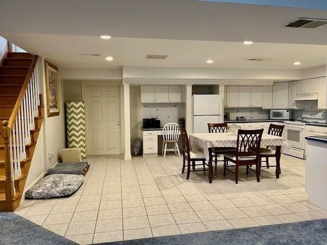 dining space featuring light tile patterned floors, recessed lighting, stairs, and visible vents