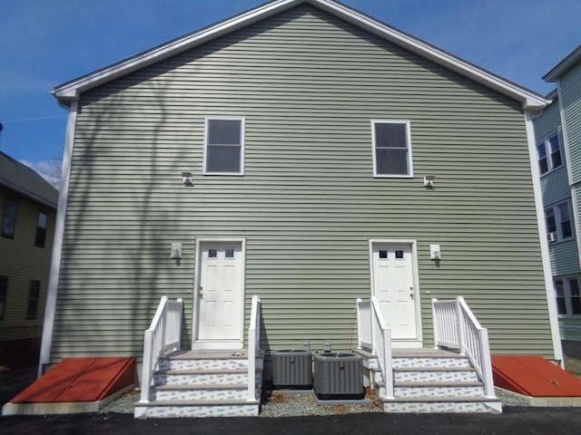 back of house featuring cooling unit