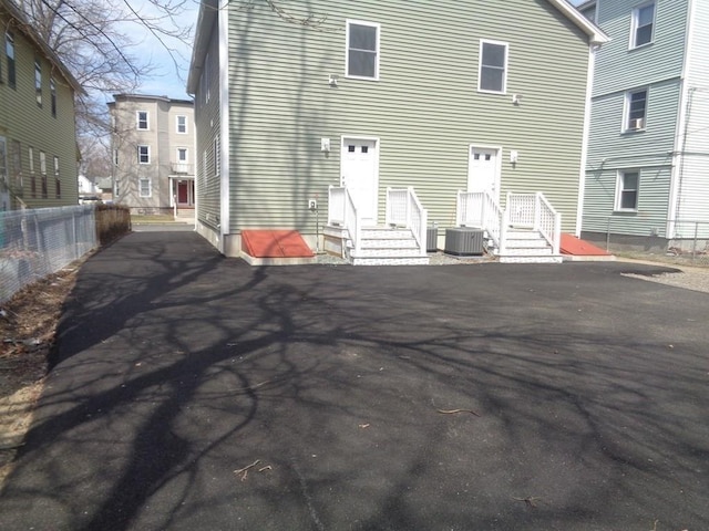 back of house with central AC unit