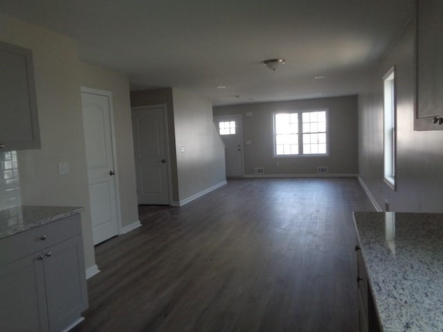 unfurnished living room featuring dark wood-type flooring