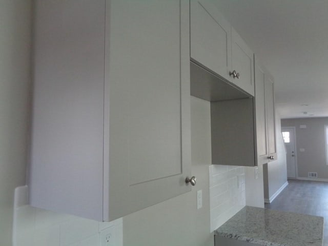 interior space featuring hardwood / wood-style floors and decorative backsplash