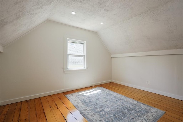 28 Custer St, Rockland, MA 02370 - bonus room featuring a textured ceiling, baseboards, vaulted ceiling, and hardwood / wood-style floors