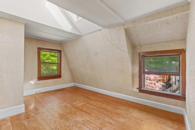 676 Salem St, Groveland, MA 01834 - unfurnished room with hardwood / wood-style flooring, a skylight, baseboards, and vaulted ceiling
