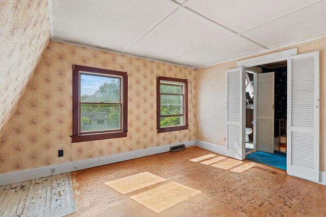 676 Salem St, Groveland, MA 01834 - unfurnished bedroom featuring hardwood / wood-style flooring, baseboards, and wallpapered walls