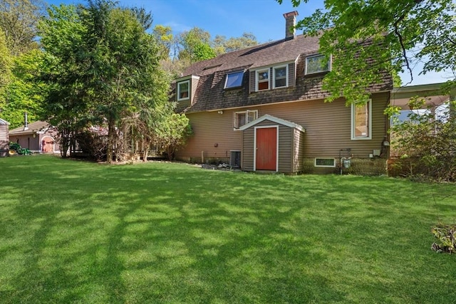 676 Salem St, Groveland, MA 01834 - back of property featuring a lawn, a storage shed, and central air condition unit