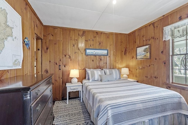 bedroom featuring wooden walls