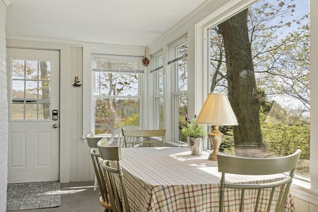 sunroom / solarium featuring ornamental molding