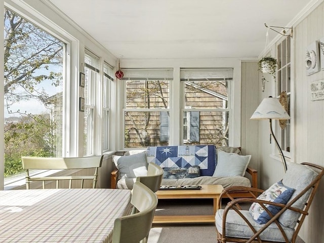 sunroom / solarium featuring crown molding