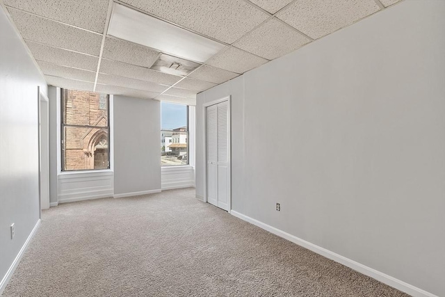 104 Pleasant St, Worcester, MA 01609 - carpeted spare room featuring a paneled ceiling and baseboards