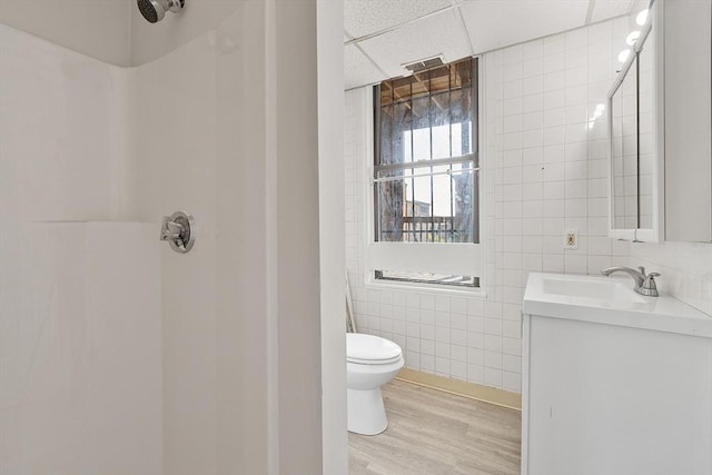 104 Pleasant St, Worcester, MA 01609 - full bathroom with tile walls, wood finished floors, vanity, and a shower