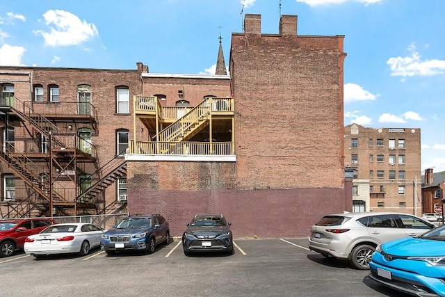 104 Pleasant St, Worcester, MA 01609 - view of building exterior featuring uncovered parking and stairs