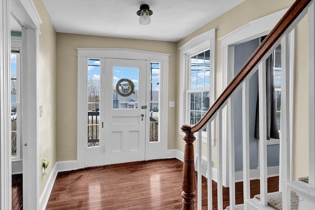entryway featuring stairway, baseboards, and wood finished floors