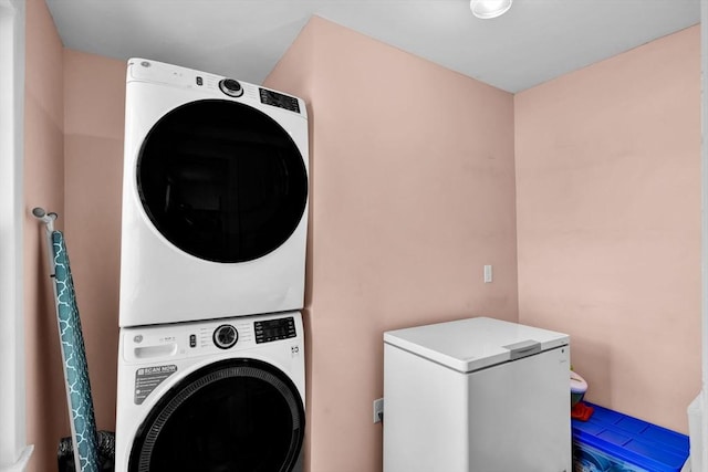 laundry area featuring stacked washing maching and dryer and laundry area