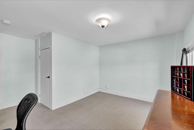 unfurnished office with baseboards and carpet floors