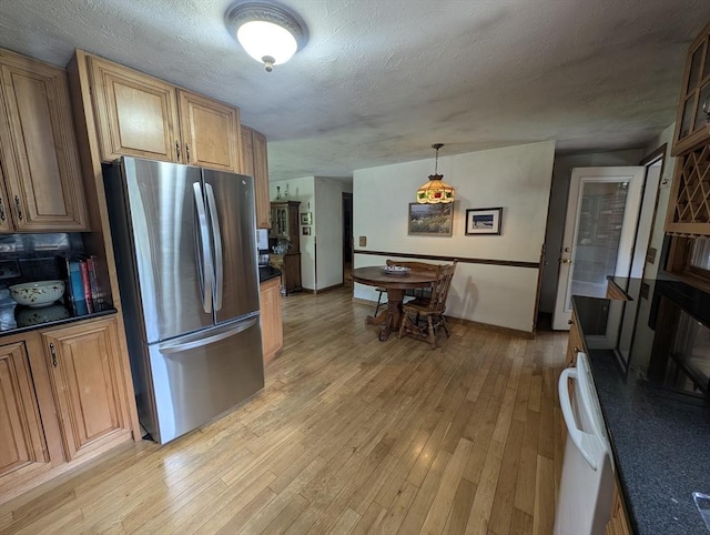 74 Ellis Rd, Southbridge, MA 01550 - kitchen featuring freestanding refrigerator, dark countertops, light wood-style flooring, baseboards, and a textured ceiling