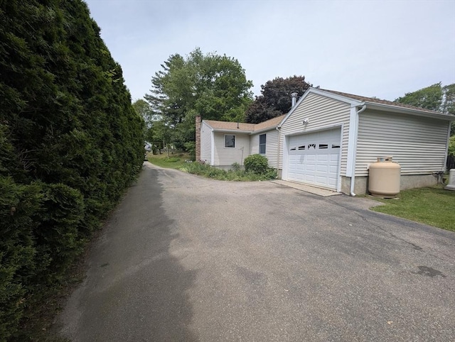 74 Ellis Rd, Southbridge, MA 01550 - view of side of property featuring driveway and a garage