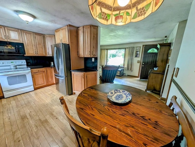 74 Ellis Rd, Southbridge, MA 01550 - kitchen featuring white electric stove, black microwave, freestanding refrigerator, a textured ceiling, and dark countertops