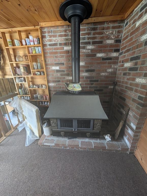 74 Ellis Rd, Southbridge, MA 01550 - detailed view of a wood stove and carpet flooring