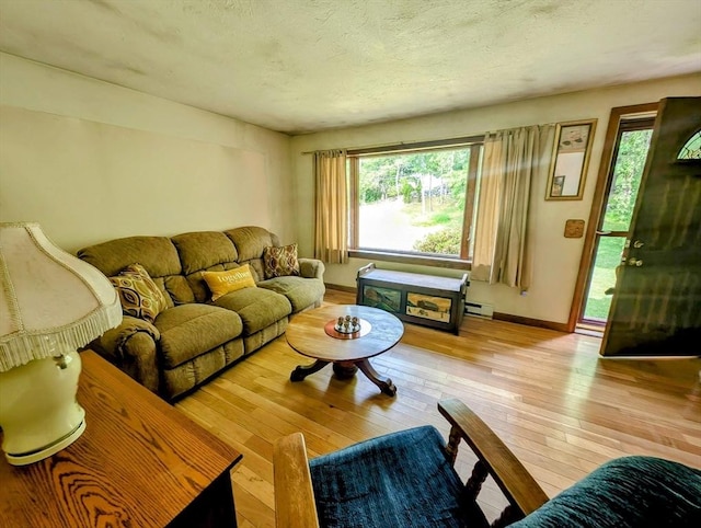 74 Ellis Rd, Southbridge, MA 01550 - living area featuring wood-type flooring, baseboards, a textured ceiling, and a baseboard heating unit
