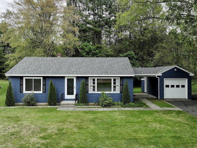 4 Norman Cir, Montague, MA 01376 - single story home with driveway, a garage, a front lawn, and roof with shingles