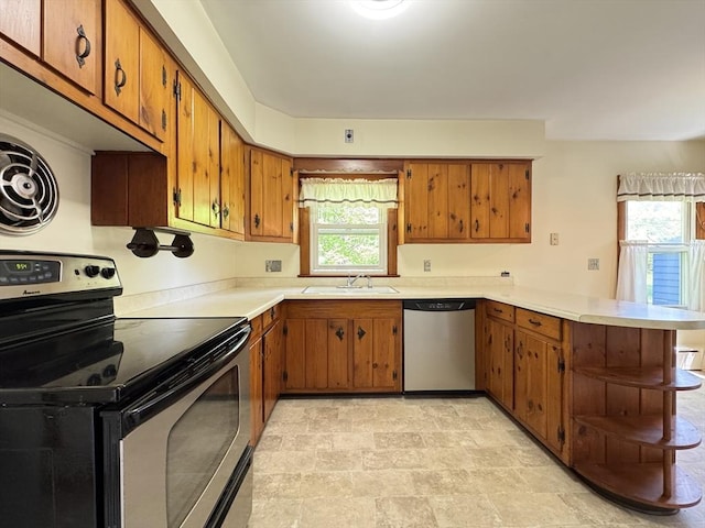 4 Norman Cir, Montague, MA 01376 - kitchen featuring stainless steel appliances, a peninsula, brown cabinetry, and open shelves