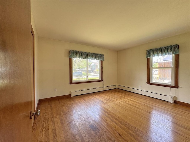 4 Norman Cir, Montague, MA 01376 - empty room with wood finished floors, baseboard heating, and baseboards