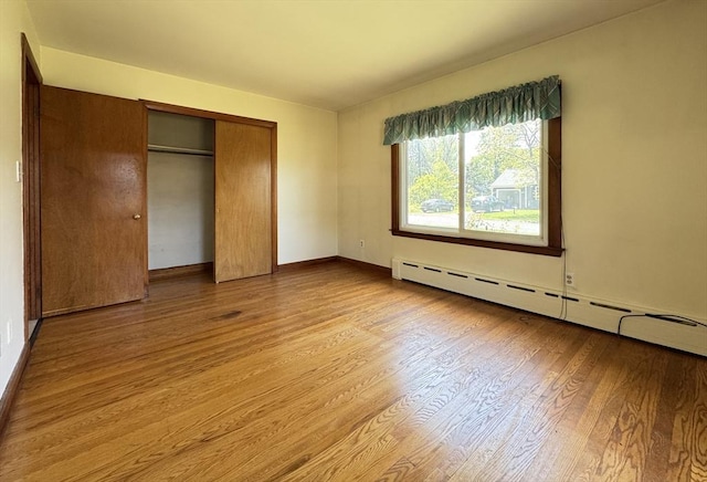 4 Norman Cir, Montague, MA 01376 - unfurnished bedroom with a baseboard heating unit, light wood-style floors, a closet, and baseboards