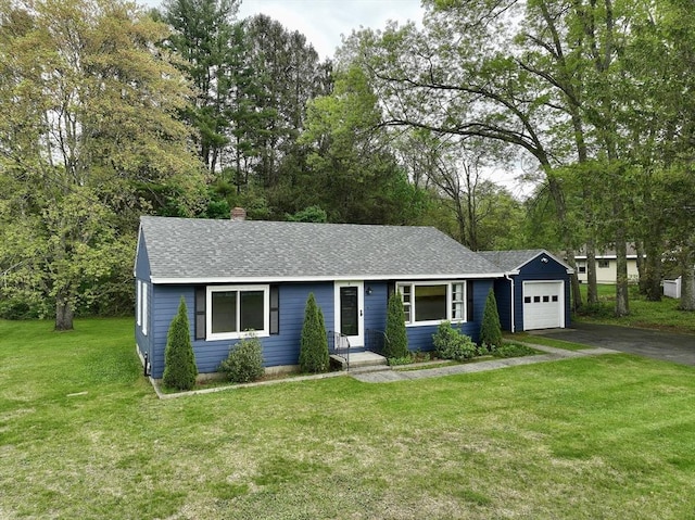 4 Norman Cir, Montague, MA 01376 - single story home with an attached garage, asphalt driveway, a front lawn, roof with shingles, and a chimney
