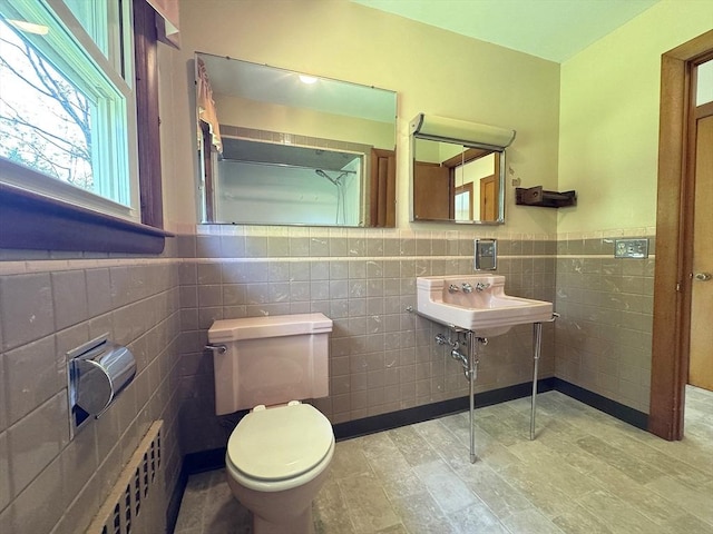 4 Norman Cir, Montague, MA 01376 - bathroom with tile walls, toilet, a sink, radiator, and a wainscoted wall