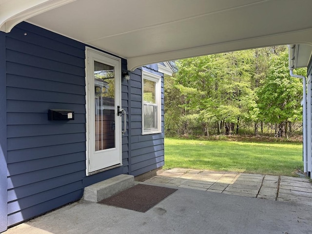 4 Norman Cir, Montague, MA 01376 - property entrance featuring a yard and a patio