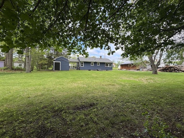 4 Norman Cir, Montague, MA 01376 - view of green lawn with a storage unit and an outdoor structure