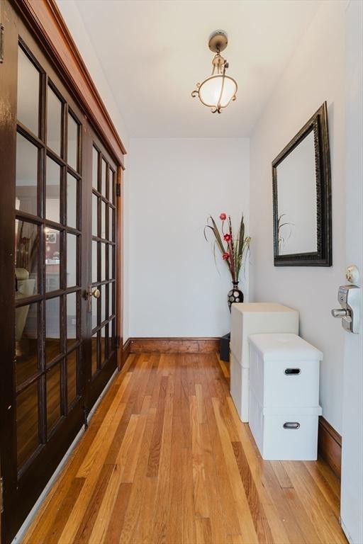 hallway with light hardwood / wood-style flooring