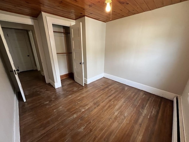 59 Carson Ave Unit 59, Clarksburg, MA 01247 - unfurnished bedroom with baseboards, wood ceiling, dark wood-style flooring, a closet, and a baseboard heating unit