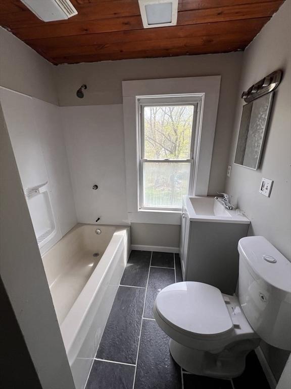 59 Carson Ave Unit 59, Clarksburg, MA 01247 - bathroom featuring wood ceiling, toilet, vanity, tile patterned floors, and washtub / shower combination