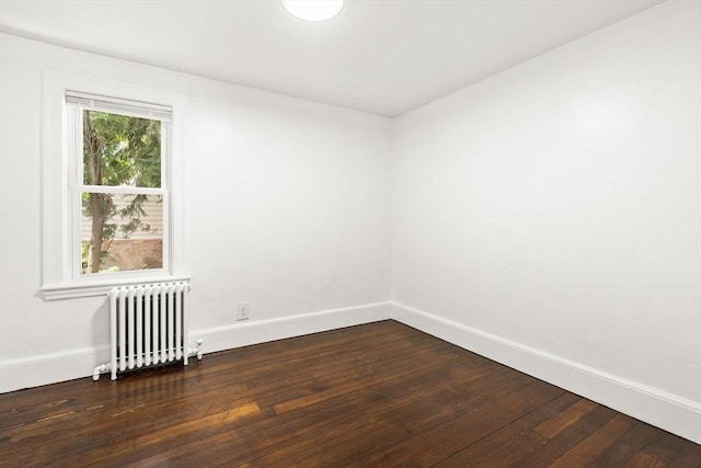 19 Arlington Rd, Dedham, MA 02026 - empty room with radiator and dark wood finished floors