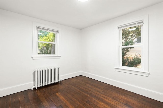19 Arlington Rd, Dedham, MA 02026 - spare room featuring radiator heating unit and dark wood-style floors
