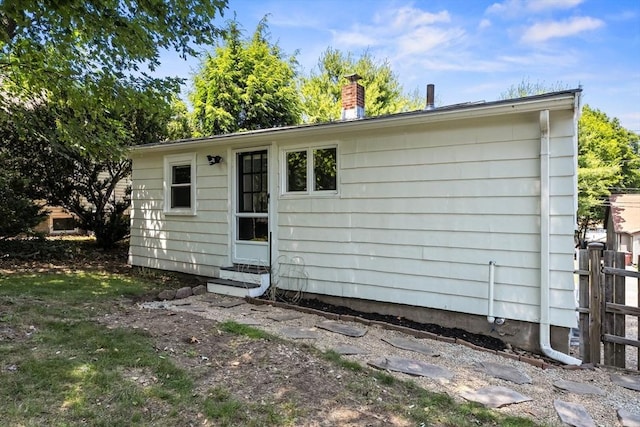 19 Arlington Rd, Dedham, MA 02026 - rear view of house featuring entry steps and a chimney
