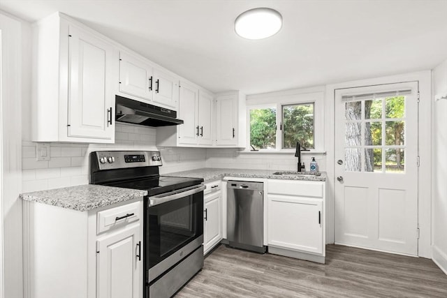 19 Arlington Rd, Dedham, MA 02026 - kitchen featuring stainless steel appliances, under cabinet range hood, healthy amount of natural light, and white cabinets