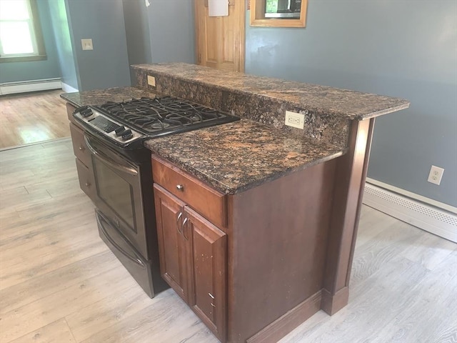 205 Gardner Rd, Hubbardston, MA 01452 - kitchen with gas range, a center island, light wood-style floors, dark stone counters, and a baseboard radiator