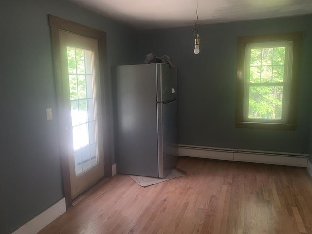 205 Gardner Rd, Hubbardston, MA 01452 - unfurnished dining area featuring baseboard heating, plenty of natural light, and light wood-style flooring