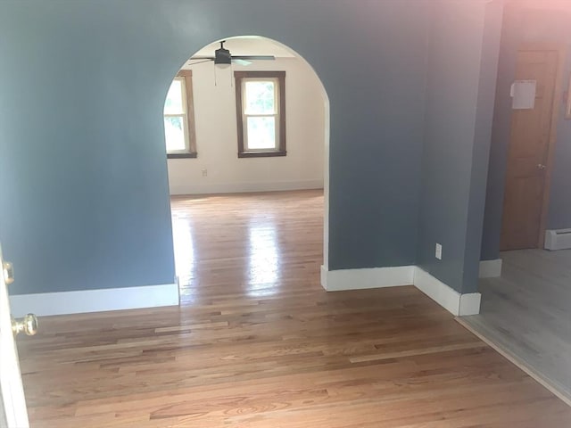 205 Gardner Rd, Hubbardston, MA 01452 - empty room featuring arched walkways, ceiling fan, and wood finished floors