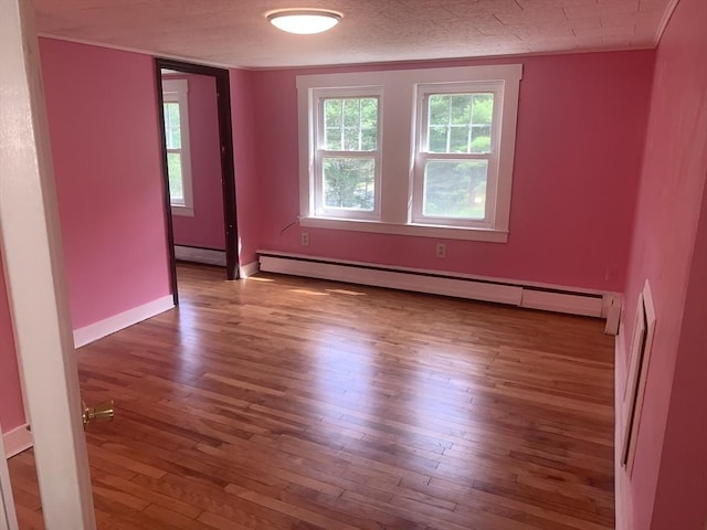 205 Gardner Rd, Hubbardston, MA 01452 - unfurnished room with a baseboard heating unit, hardwood / wood-style floors, and healthy amount of natural light