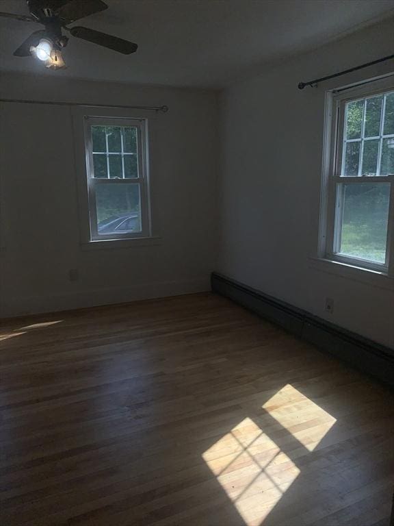 205 Gardner Rd, Hubbardston, MA 01452 - unfurnished room featuring a baseboard heating unit, dark wood-type flooring, and a ceiling fan