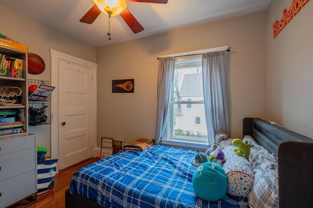 bedroom featuring ceiling fan and dark hardwood / wood-style floors