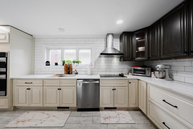 kitchen with wall chimney exhaust hood, sink, tasteful backsplash, black electric cooktop, and stainless steel dishwasher