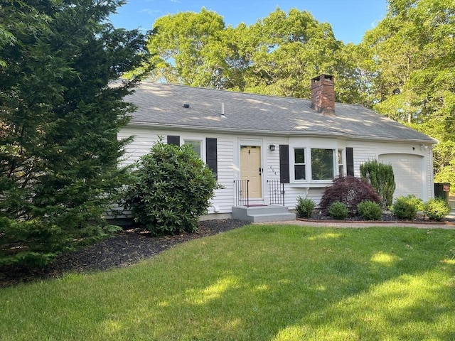 ranch-style home with a garage and a front lawn