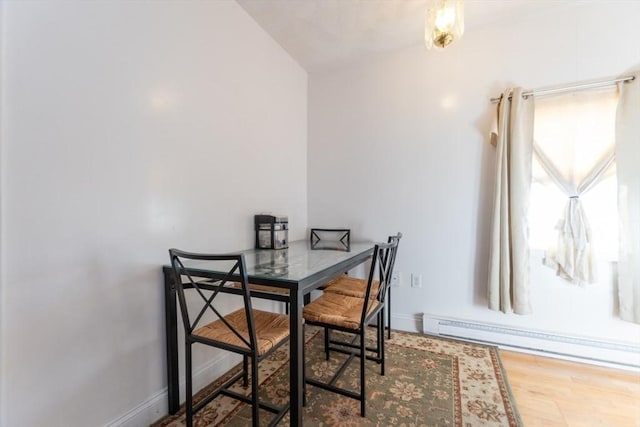 dining room featuring hardwood / wood-style flooring and baseboard heating