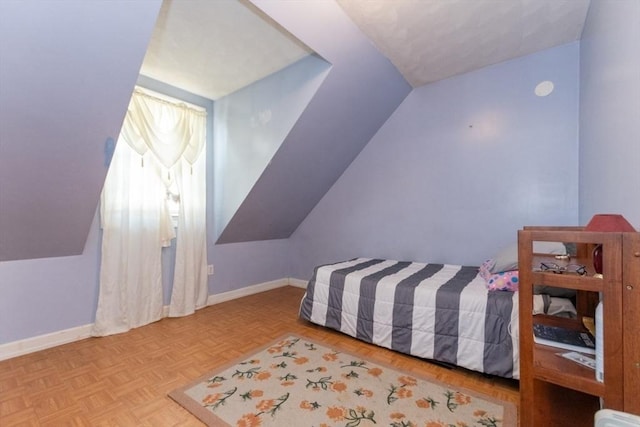 bedroom featuring light parquet floors and lofted ceiling