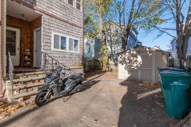 view of side of home featuring a storage shed