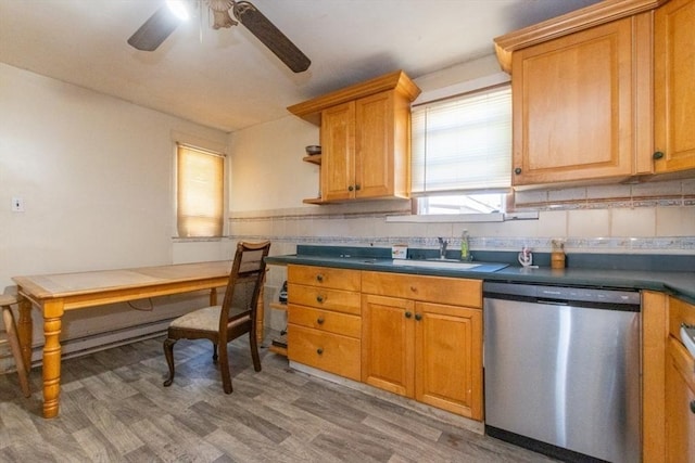 kitchen with hardwood / wood-style flooring, stainless steel dishwasher, ceiling fan, and sink